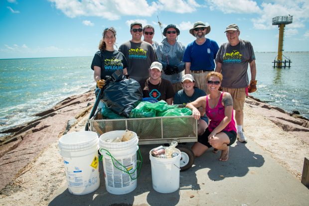 Zoo staff cleaning up the Surfside Jetty. 