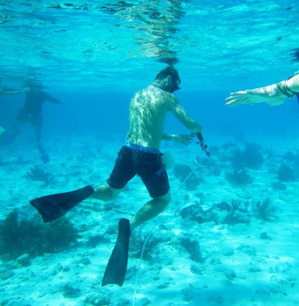 Juan Sebastian conducting marine transects to find out more about fish behavior in Belize.