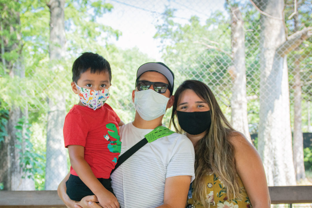family wearing face masks at the Zoo